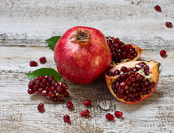 istock Ripe juicy pomegranate on wooden table 471350300