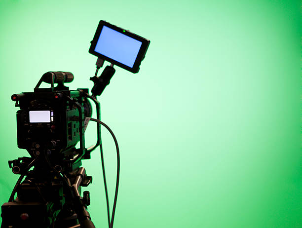 Television Camera on Green Screen Background Television camera on green screen background with video display. film studio stock pictures, royalty-free photos & images