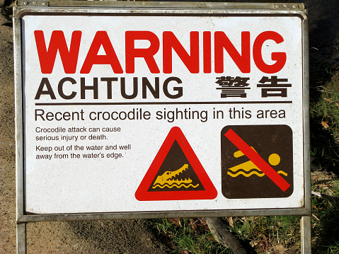 Crocodile warning sign. Achtung