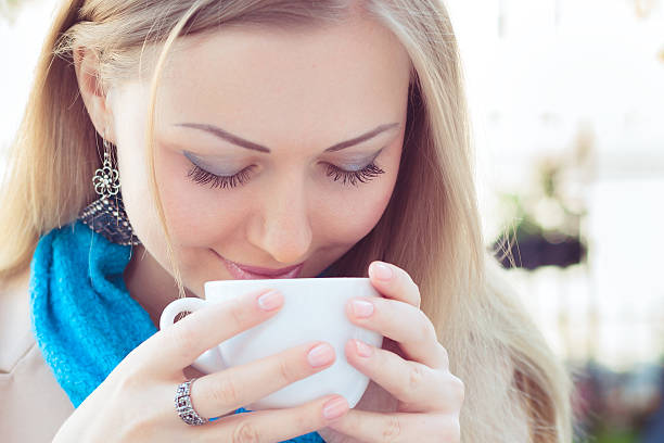 istock woman smell the cappuccino 471354190