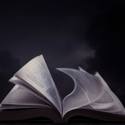 Open book with dark sky on background