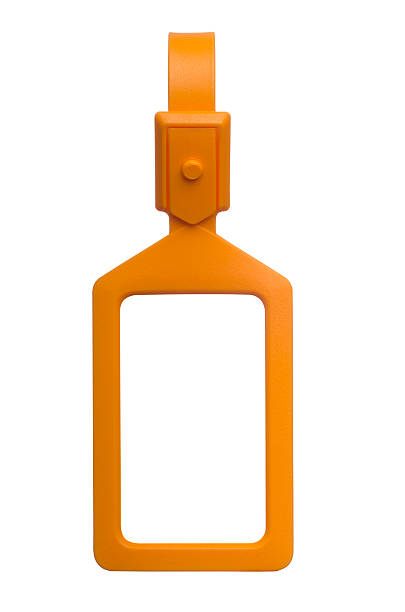 Vertical orange luggage tag with clipping paths A studio shot of an orange plastic luggage tag isolated on a white background with clipping paths for both the tag and the background luggage tag stock pictures, royalty-free photos & images