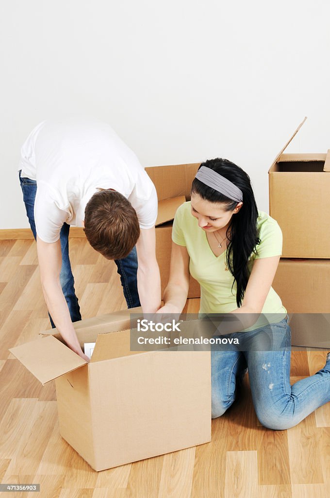 moving Young man and woman in the room with boxes for moving Adult Stock Photo