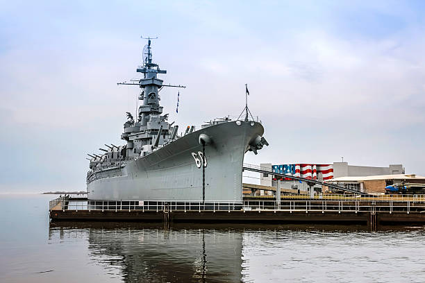 USS Wisconsin battleship of the US Navy tied to the dock in harbor as a tourist attraction, vintage military equipment, Norfolk, Virginia, VA, USA. 