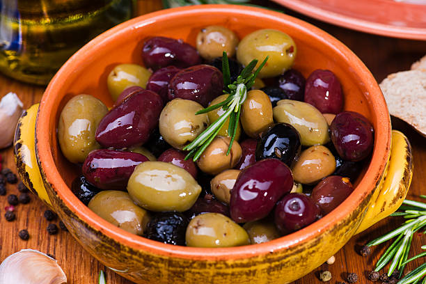 istock Olives in bow with prosciutto on wooden table 471357782