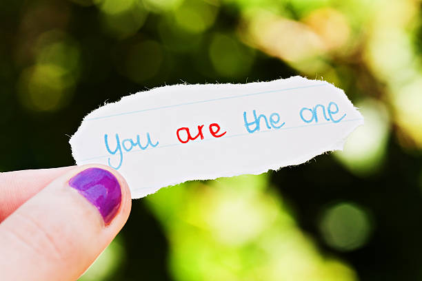 istock Woman's hand holds hand-drawn message: you are the one 471357859