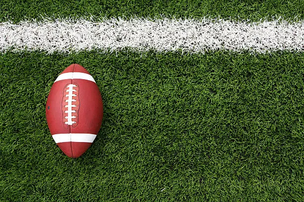 Photo of Overhead view of a football lying on a football field