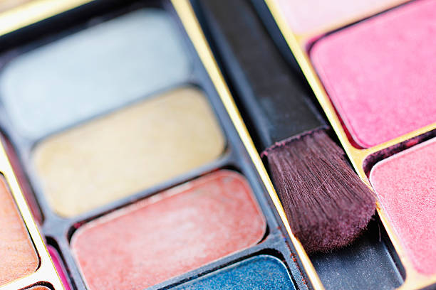 istock Multicolored eye shadows and cosmetics brush 471360337