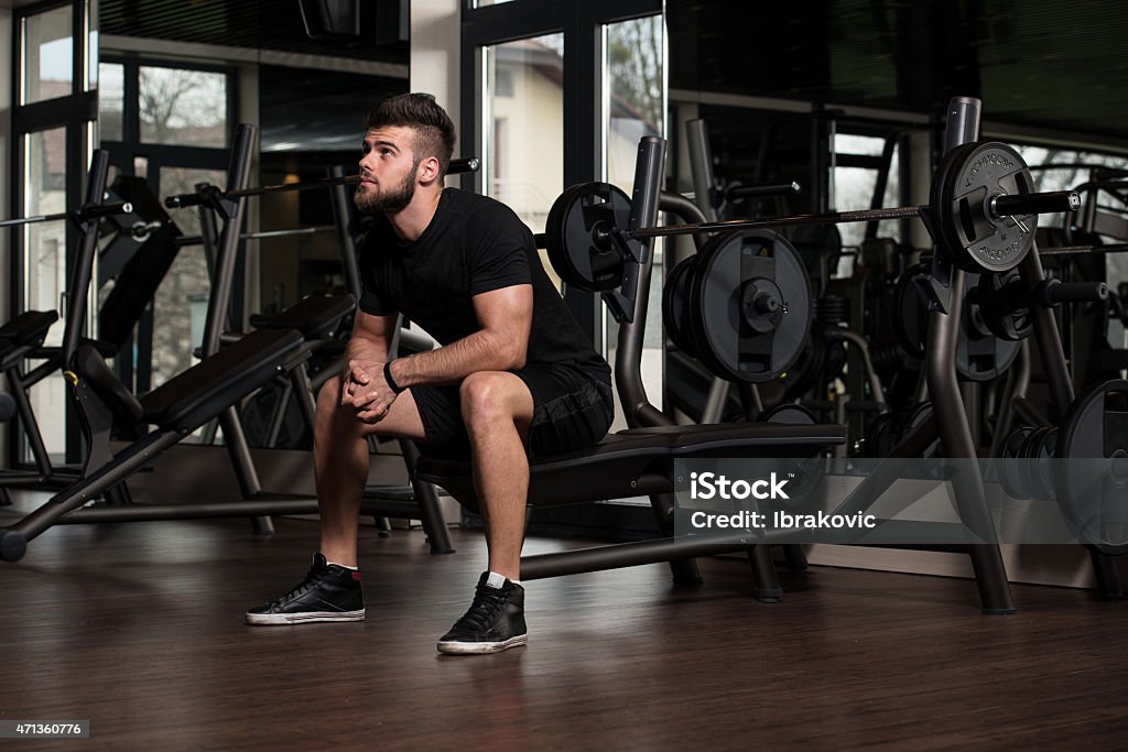 Resting Between Sets And Exercises Portrait Of A Physically Fit Young Man Resting In A Health Modern Club Bench Stock Photo