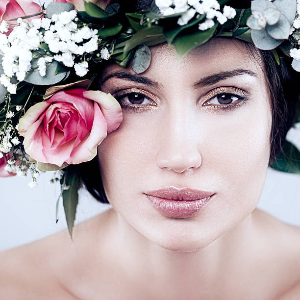 Spring Fairy Portrait of a beautiful Caucasian woman with leaves and flowers in her hair. beauty and beast rose stock pictures, royalty-free photos & images