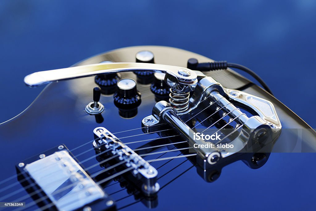 Guitar with Tremolo Sky reflection on ebony guitar with tremolo. Guitar Stock Photo