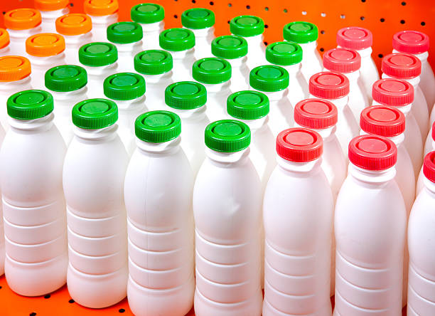 istock dairy products bottles with bright covers on  shelf in  shop 471363478