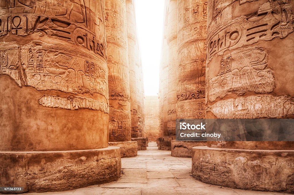 Great Hypostyle Hall / Precinct of Amun-Re ( Karnak Temple Complex ) The Karnak Temple Complex comprises a vast mix of decayed temples, chapels, pylons, and other buildings. Building at the complex began in the reign of Sesostris I in the Middle Kingdom and continued into the Ptolemaic period, although most of the extant buildings date from the New Kingdom. The area around Karnak was the ancient Egyptian Ipet-isut ("The Most Selected of Places") and the main place of worship of the eighteenth dynasty Theban Triad with the god Amun as its head. It is part of the monumental city of Thebes. The Karnak complex takes its name from the nearby, and partly surrounded, modern village of el-Karnak, some 2.5 km north of Luxor. Egypt Stock Photo