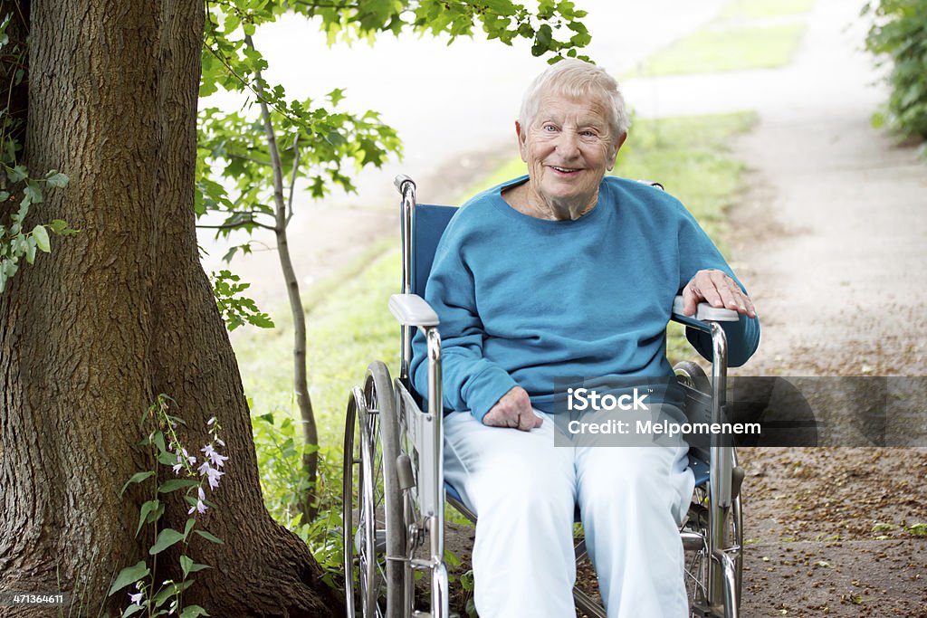 Senior Lady in Wheelchair Smiling Senior Women in a Wheelchair Smiling Outside Joy Stock Photo