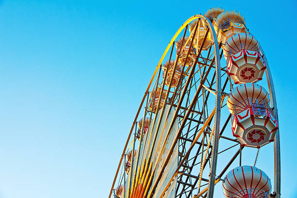 istock ferris wheel at sunrise 471365863