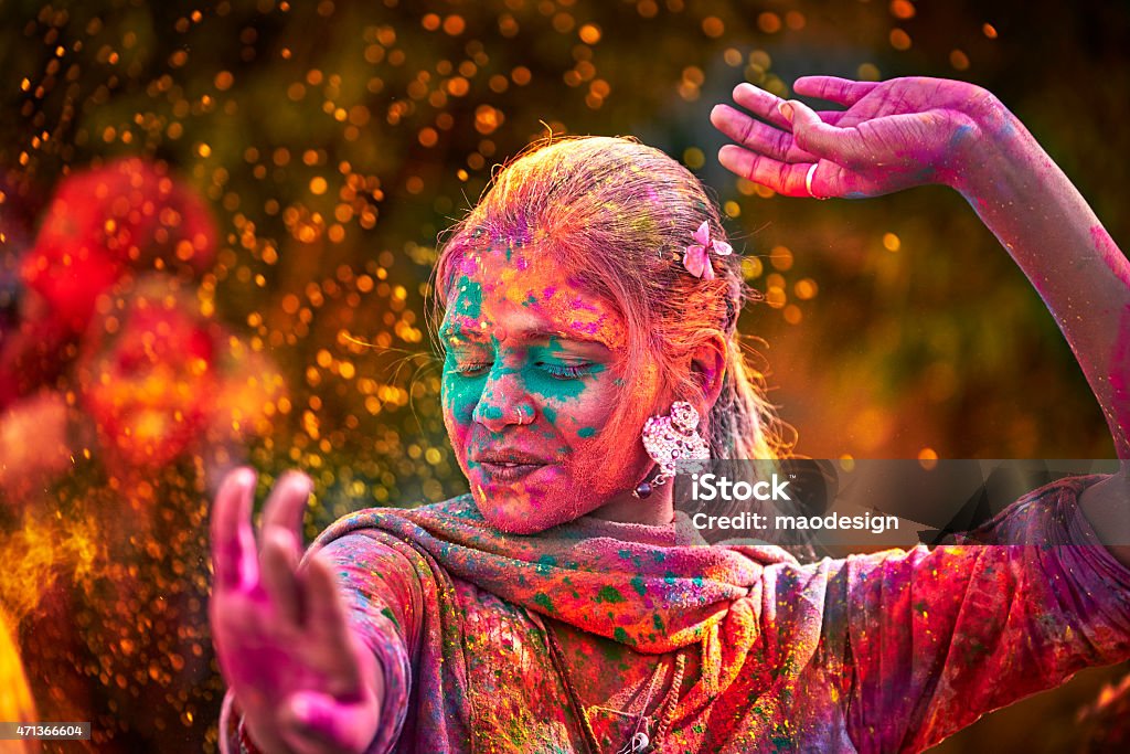 Portrait Of Indian Woman With Colored Face Dancing During Holi Portrait Of Young Indian Woman With Colored Face Dancing During Holi India Stock Photo