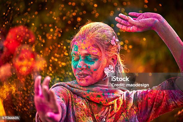 Portrait Of Indian Woman With Colored Face Dancing During Holi Stock Photo - Download Image Now