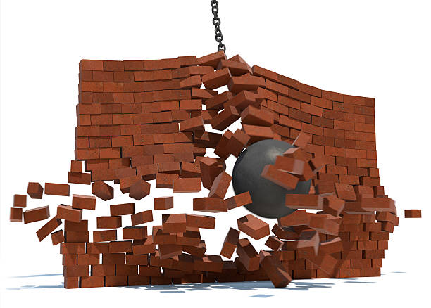 istock Wrecking ball crashing through brick wall 471366937