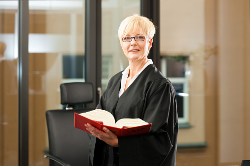 Female lawyer with German civil law code in a court room