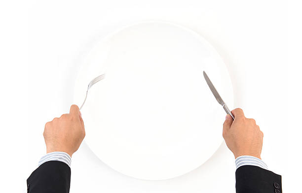 istock hand hold fork and knife with white plate 471367080