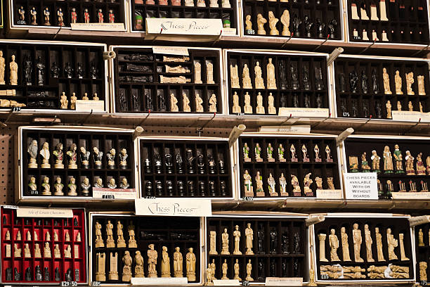 London, England - March 12, 2011: Chess pieces on sale in a market, many sets with different characters.