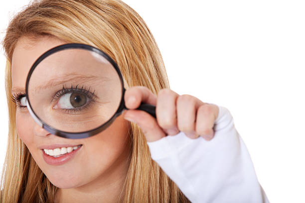 istock Teenage girl looking through magnifier 471368337
