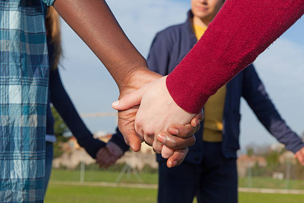 istock Multiracial Young People Holding Hands in a Circle 471368599