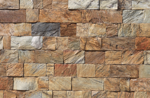 Stone brown old wall vintage texture panoramic large background brick siding different sized stones