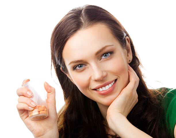 istock Woman showing bottle with pills, on white 471368735