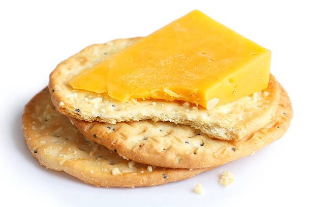 istock Three golden cheese crackers on white. With cheese. 471369454