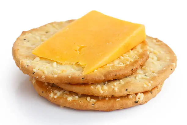 Photo of Three golden cheese crackers with cheese on white background