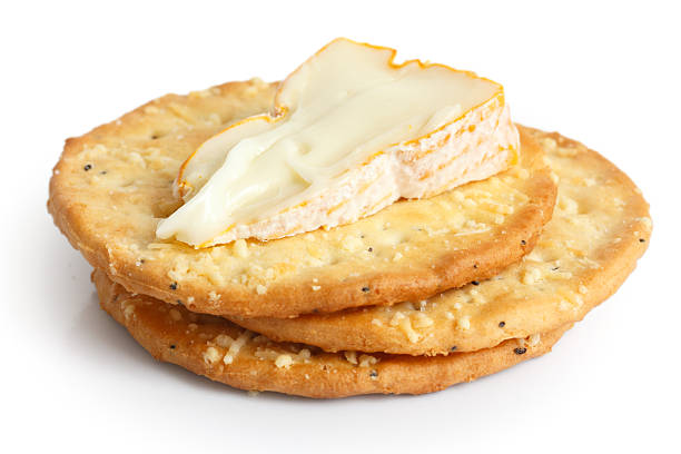 istock Three golden cheese crackers on white. With cheese. 471369464