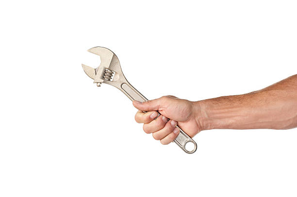 hombre mano agarrando una llave en forma de medialuna - wrench fotografías e imágenes de stock