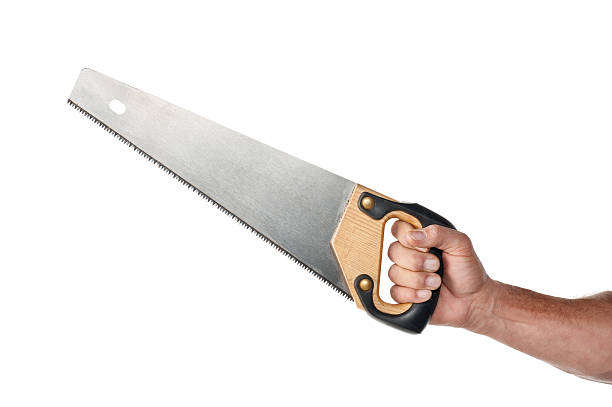 Male Hand Holding A Handsaw Male handyman's hand holding a handsaw. The shot was done in the studio shot against a white background. hand saw photos stock pictures, royalty-free photos & images