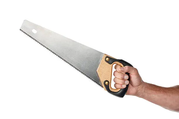 Male handyman's hand holding a handsaw. The shot was done in the studio shot against a white background.