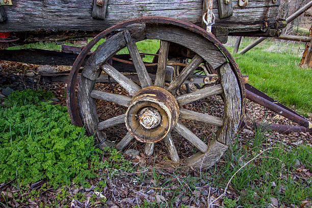 istock Antique wooden spoked wheeled wagon closeup front right view 471369806