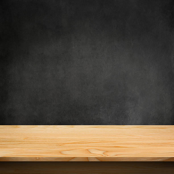 istock A piece of unstained wood with a concrete wall behind it 471370180