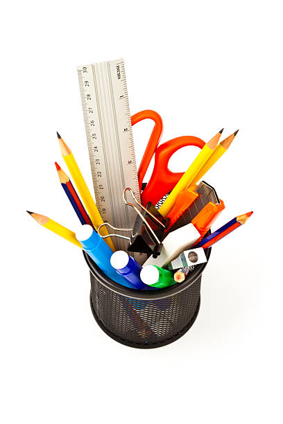istock Desk organizer filled with some office supplies on white backdrop 471370304