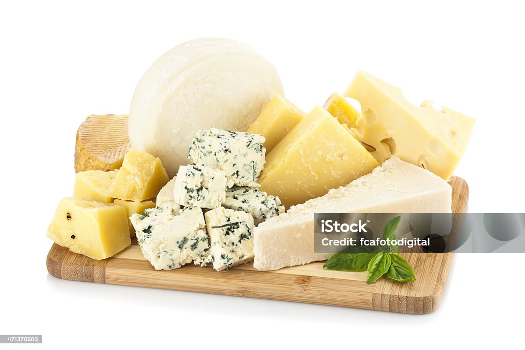 Wooden cheese board isolated on white backdrop A wooden cheese board filled with a various types of cheese shot on white backdrop. Parmesan cheese, emmental and roquefort, are some of the cheeses includes in the image.  Soft shadow of the wood board on background.  The predominant color is white and yellow. DSRL studio shot with Canon EOS 5D Mk II   Cheese Stock Photo