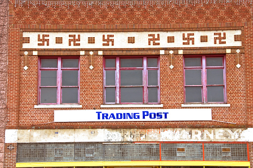 Brick building now trading post with swastika design known as \