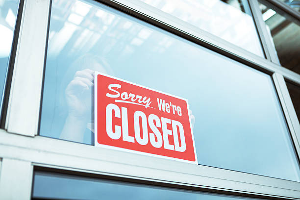 Business Closing with "Sorry We're Closed" Sign Hz Subject: Economic recession with business posting "CLOSE" sign for Closing down business. closed sign stock pictures, royalty-free photos & images