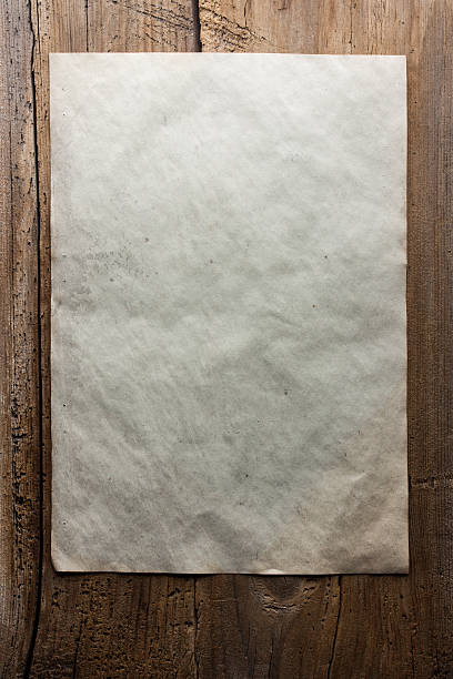 istock paper on wooden background 471372434