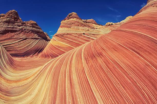 Arizona Utah Mountains Sandstone mountain waves in the Vermilion Cliffs in between Arizona and Utah.  The location is also called "The Wave". slickrock trail stock pictures, royalty-free photos & images