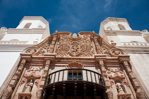 The San Xavier del Bac Mission on the Tohono O'odham Indian Reservation near Tucson, Arizona is captured on a warm spring day.  Nicknamed the 