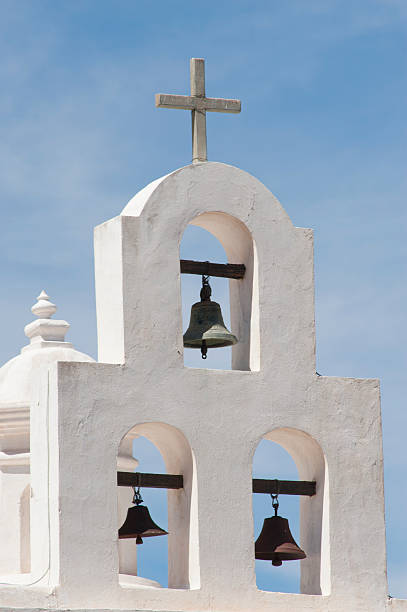 Three Bells at San Xavier del Bac Mission Three bells over the chapel at San Xavier del Bac Mission on the Tohono O'odham Indian Reservation near Tucson, Arizona are photographed on a warm spring day.  Nicknamed the "White Dove of the Desert," the mission has had a presence in this desert location since 1692; however, the buildings pictured here were completed in 1797. tohono o'odham stock pictures, royalty-free photos & images