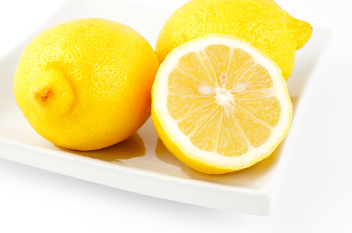 macro Lemons seeds peel cut in half square plate food fruit white background