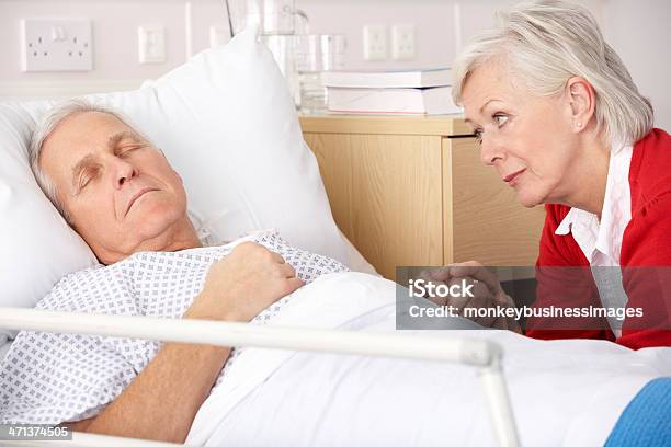 Senior Woman Visiting Husband In Hospital Stock Photo - Download Image Now - 60-69 Years, 70-79 Years, Adult