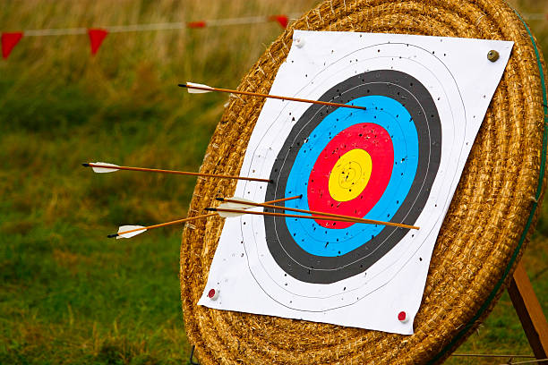 Target stand for archery with arrows in it and holes stock photo