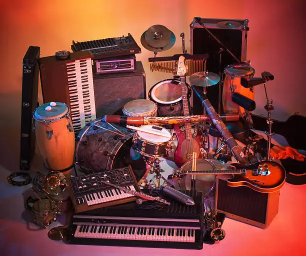 studio photography with lots of colorful illuminated music instruments mixed into each other
