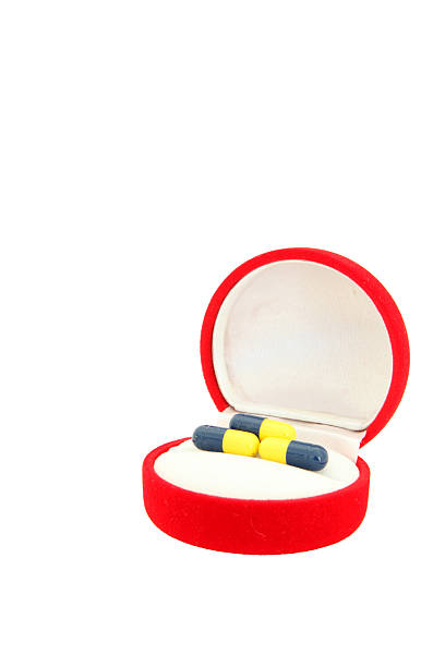 istock perspective of capsules in red velvet gift box 471378519